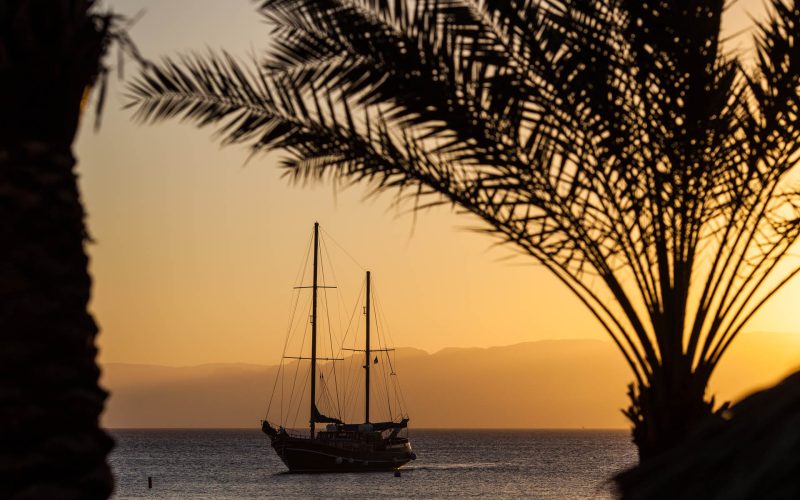 Aqaba harbor with sailing ship in the sunset on the red sea