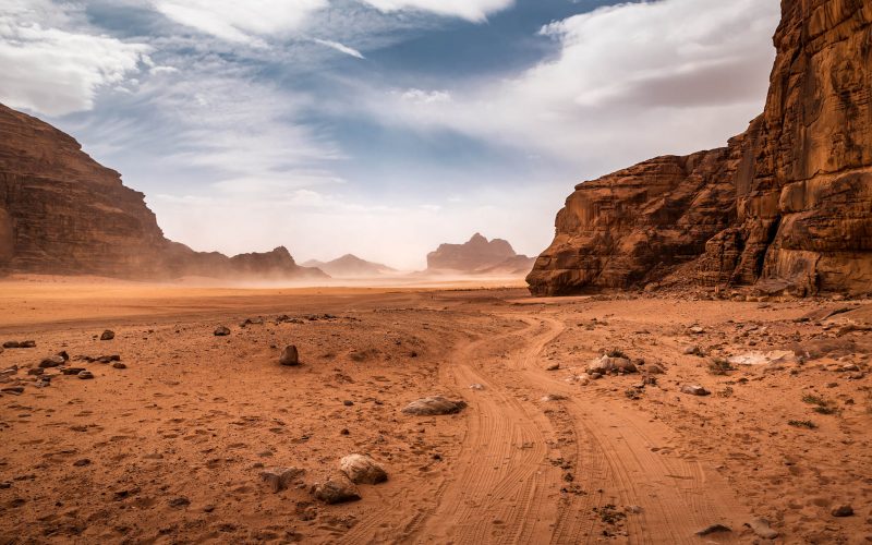 The wind raises the dust in Wadi Rum, Sahara or Arabian desert